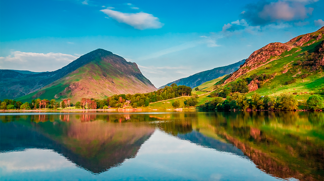 Hilly landscape mirrors in lakes surface in Lake District